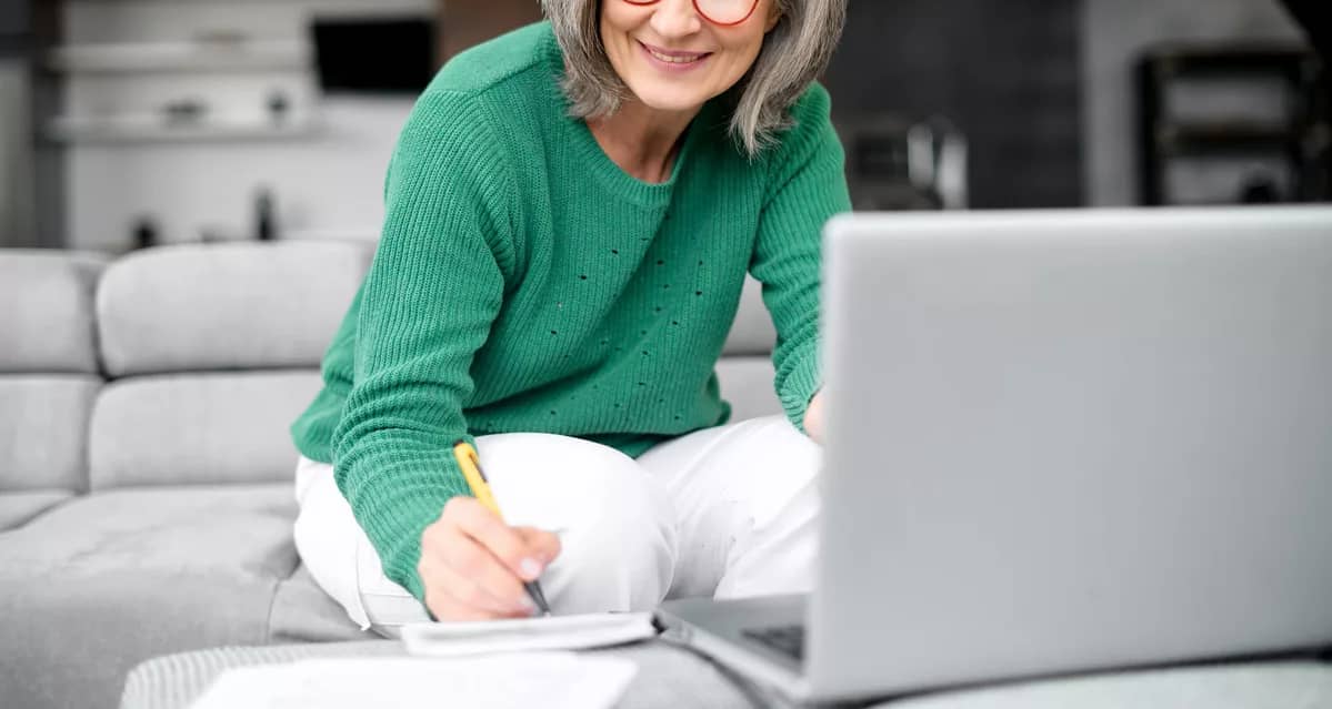 older adult in living room reviewing finances.jpg