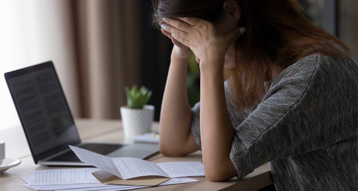 Woman appearing upset with head in her hands .width qqzych.jpg