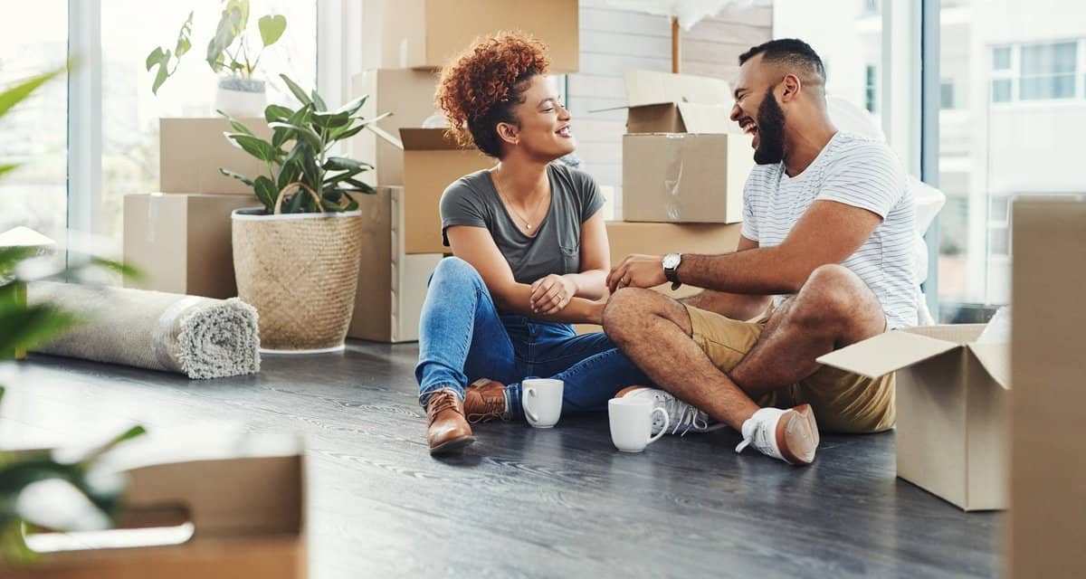 two people on floor between moving boxes kVBB.width .jpg