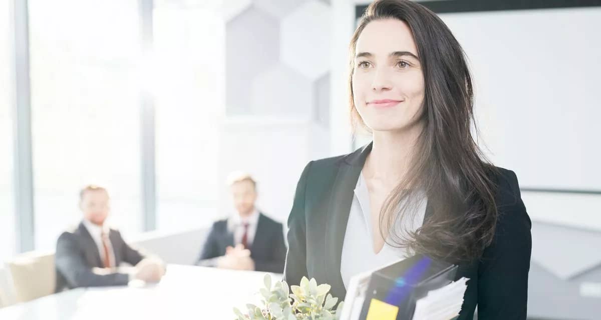 Happy businesswoman leaving job with box of b.width qZUZkS.jpg