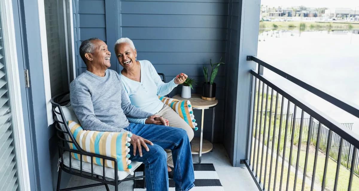 Happy mature couple sitting on balcony overlo.width gFthua.jpg
