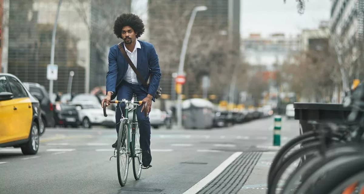 person riding bike on city street kTdlO.width .jpg