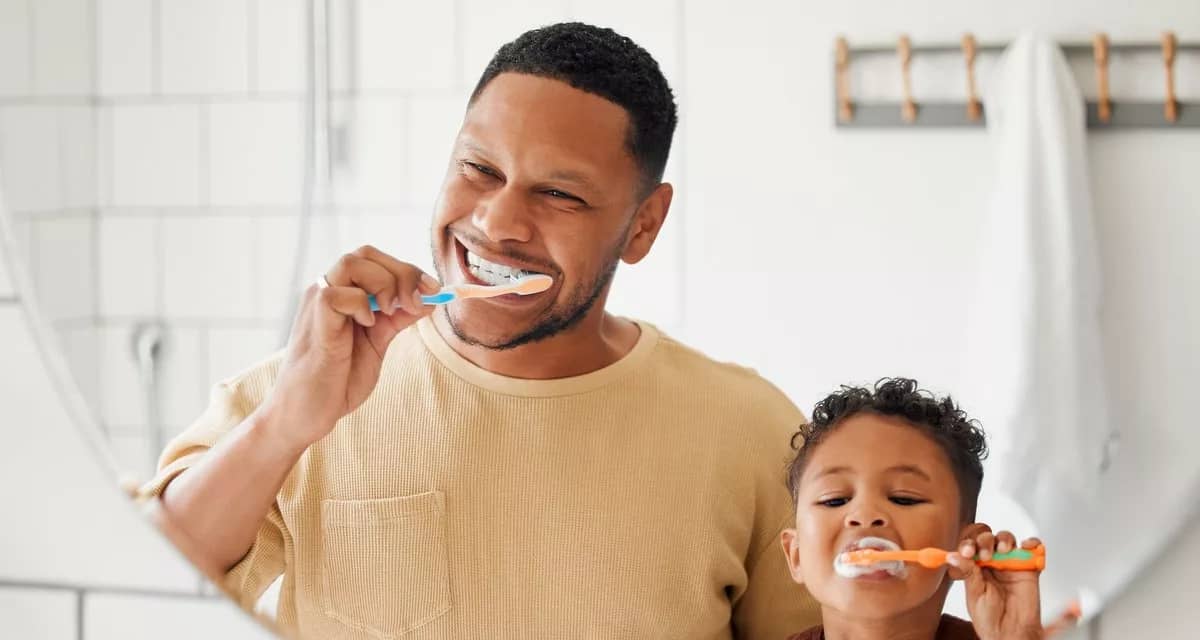 Adult and child brushing their teeth in front.width .jpg