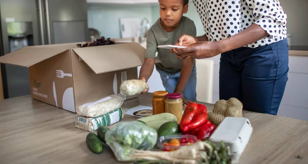 mother and son opening meal service kit.width .jpg
