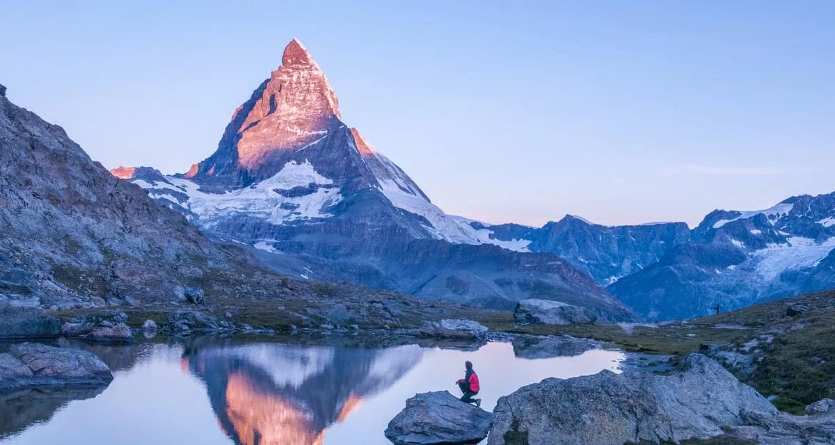 hiker in front of matterhorn mountain lake em.width .jpg
