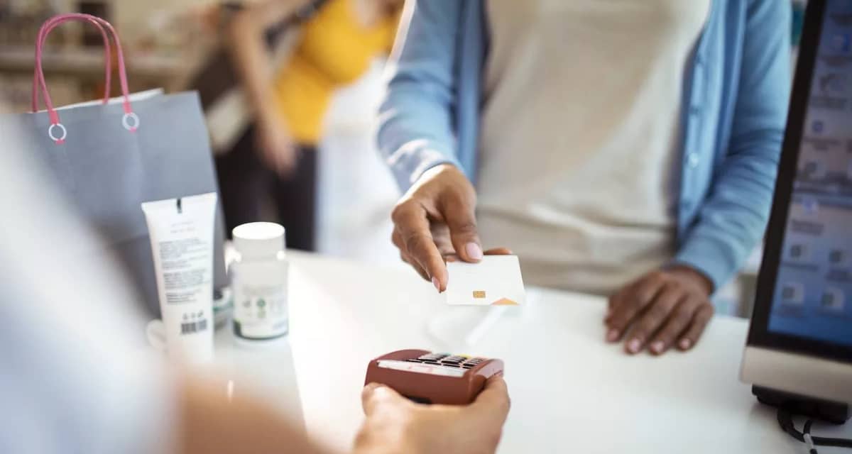 woman paying with credit card at pharmacy SRR.width .jpg