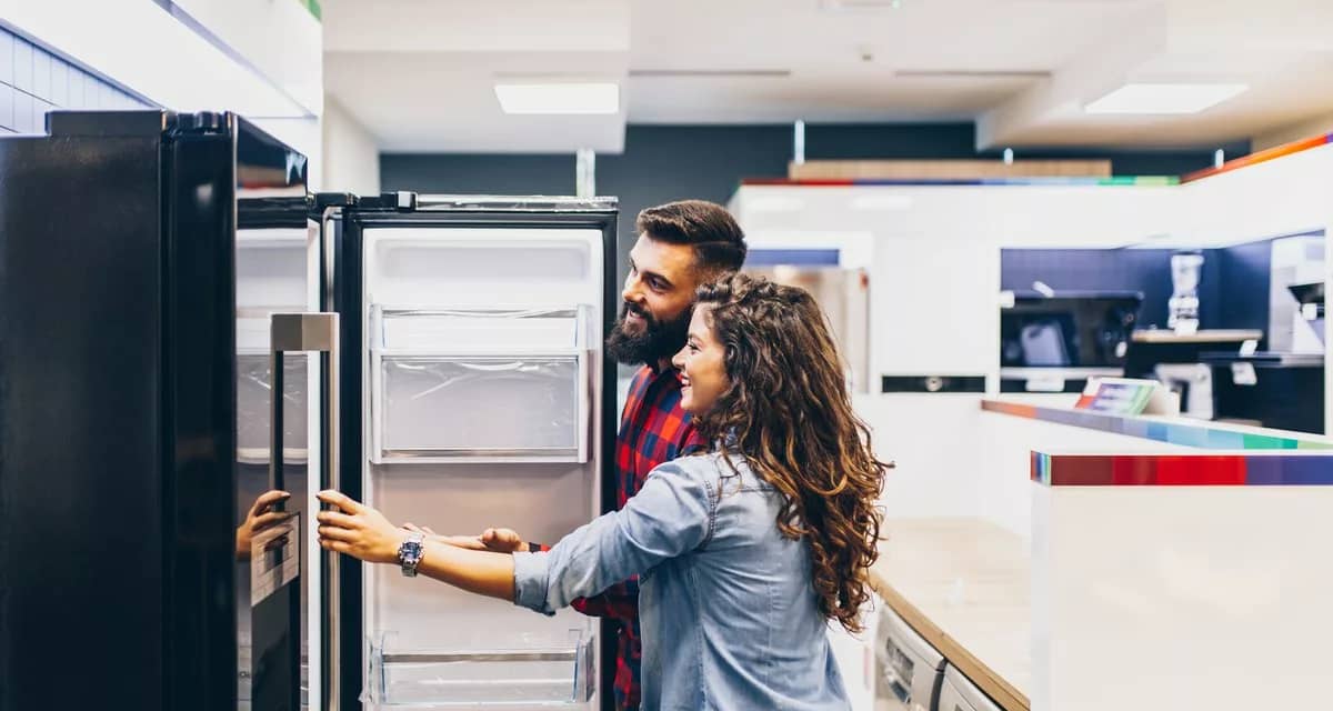 Young couple shopping for fridge.width .jpg