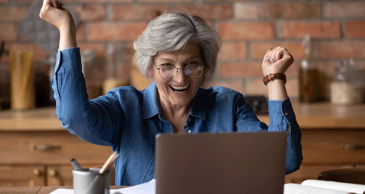 excited retiree looking at computer.jpg