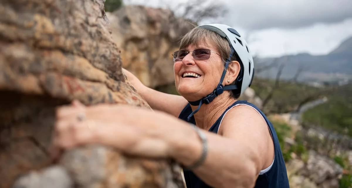 smiling person rock climbing.jpg