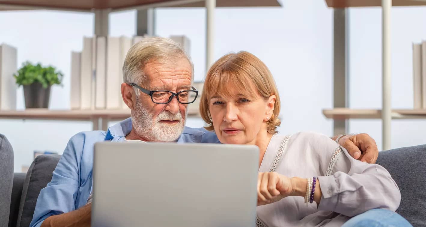 perplexed senior couple looking at laptop.jpg