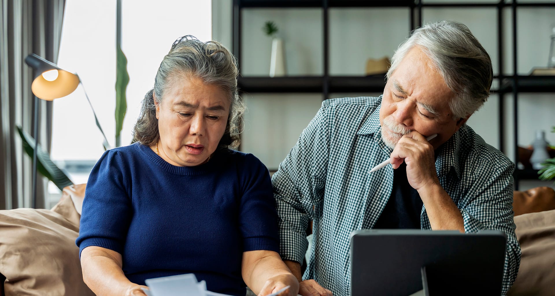 older asian couple stressed NntkJ