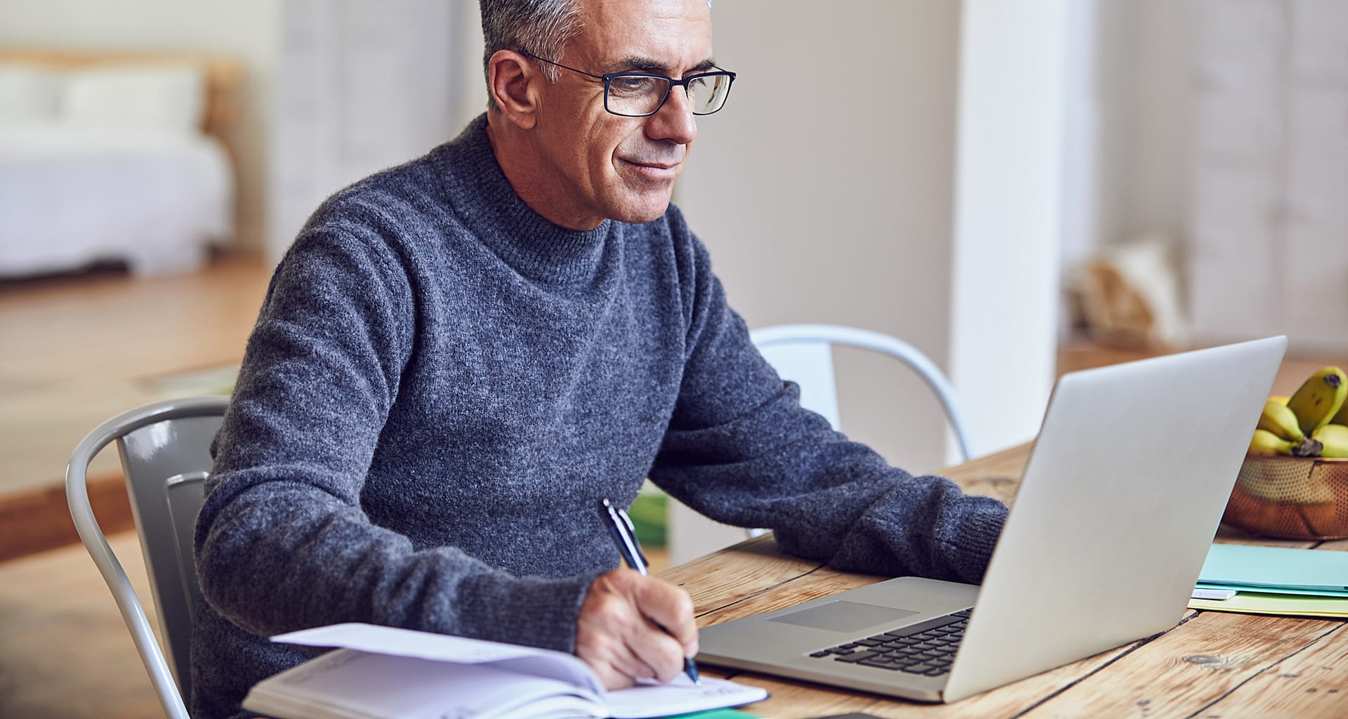 middle aged man notes laptopgettyimages KNzojl