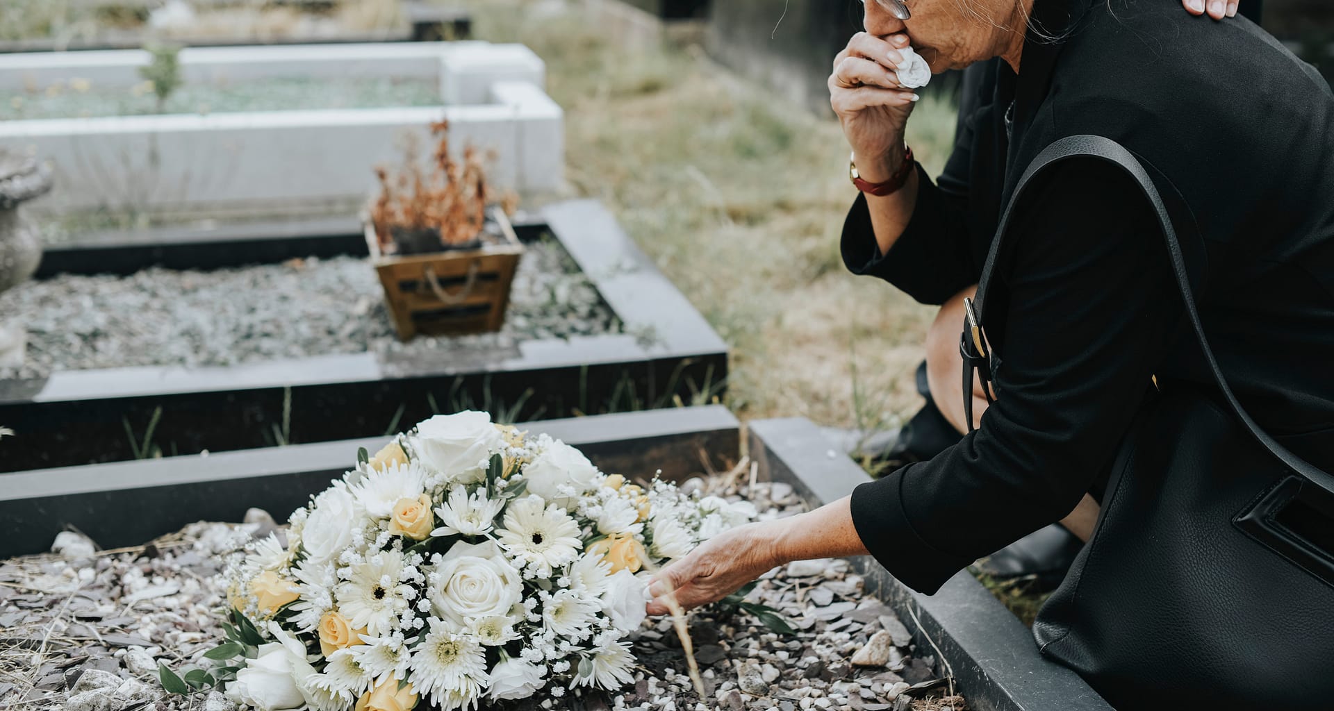 older woman at grave crying gettyimages laxCgb