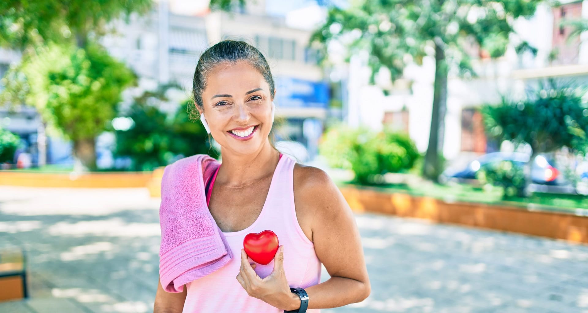 older woman exercise heart rate outdoor towel airpod cardio rJXTA