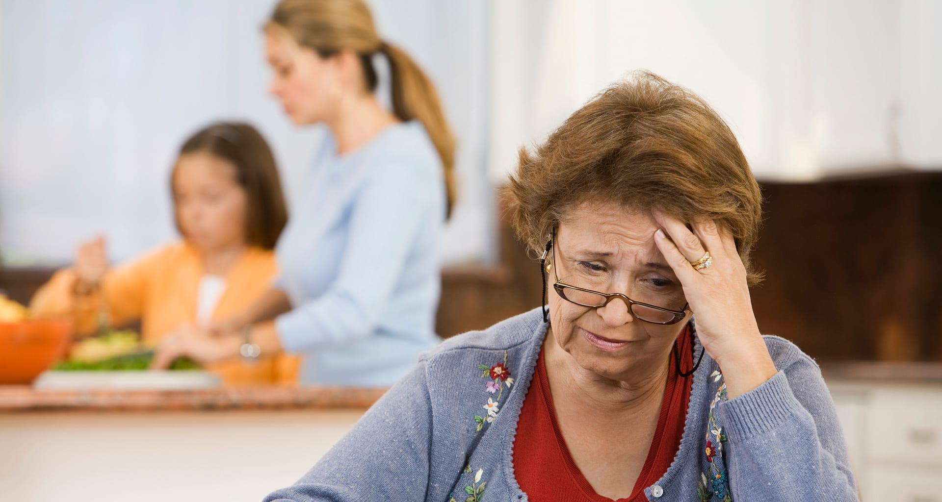 worried senior woman holding checkbook lrfD