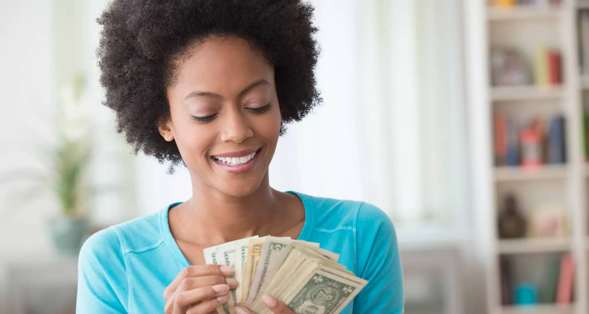 smiling person counting money.jpg