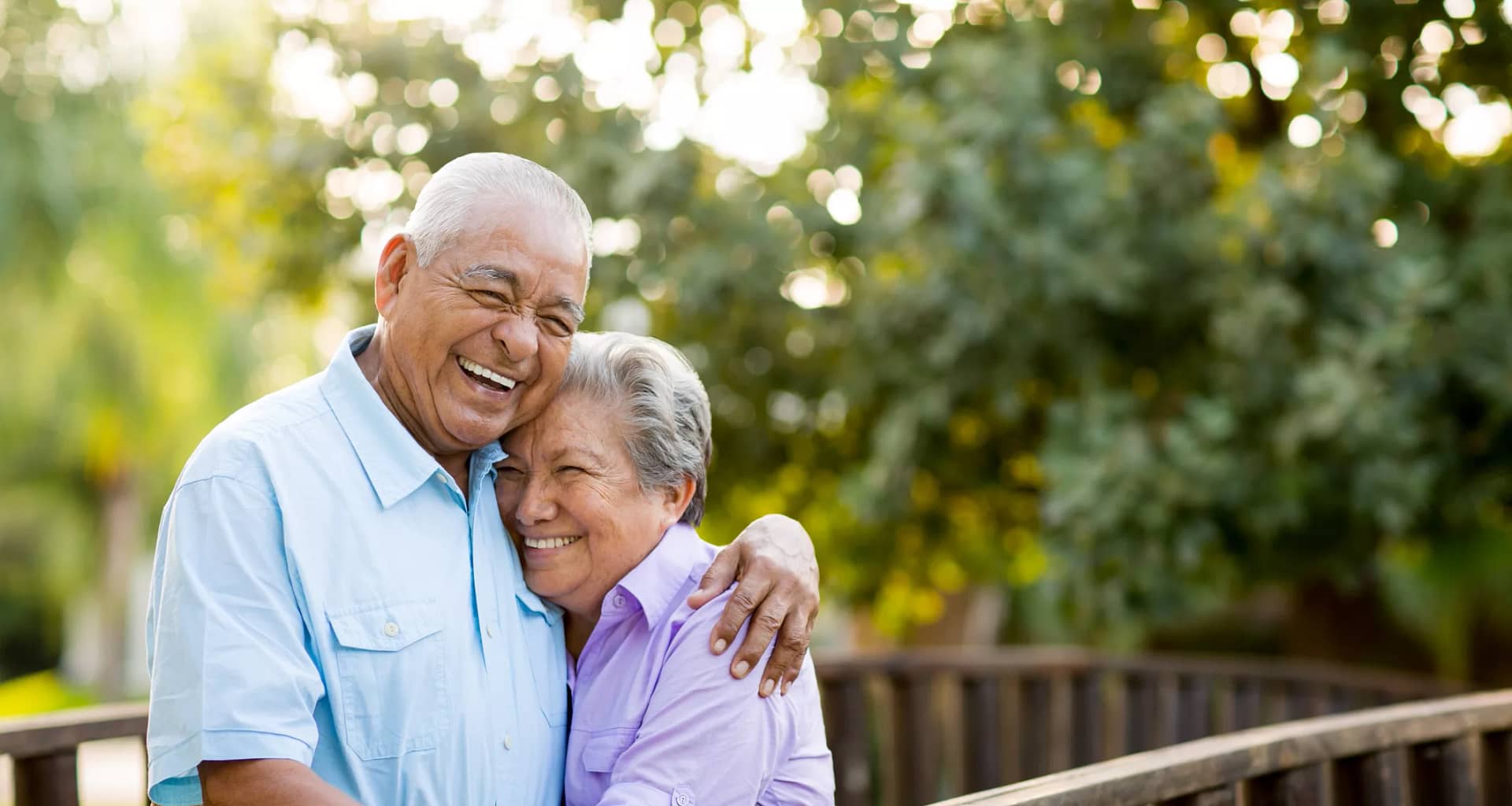 two older people standing outside hugging.jpg