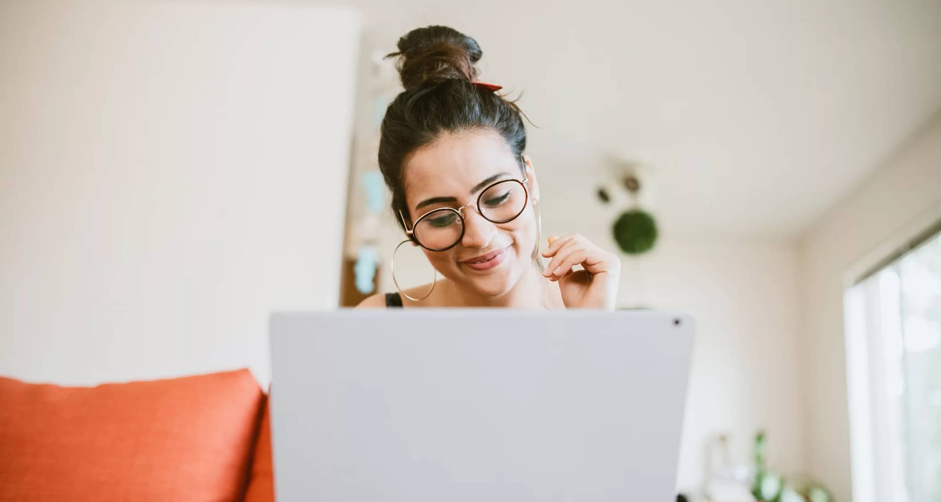 smiling person looking at laptop.jpg
