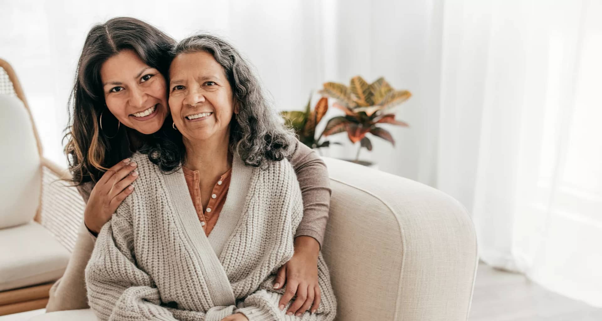 two people sitting on a couch and smiling.jpg
