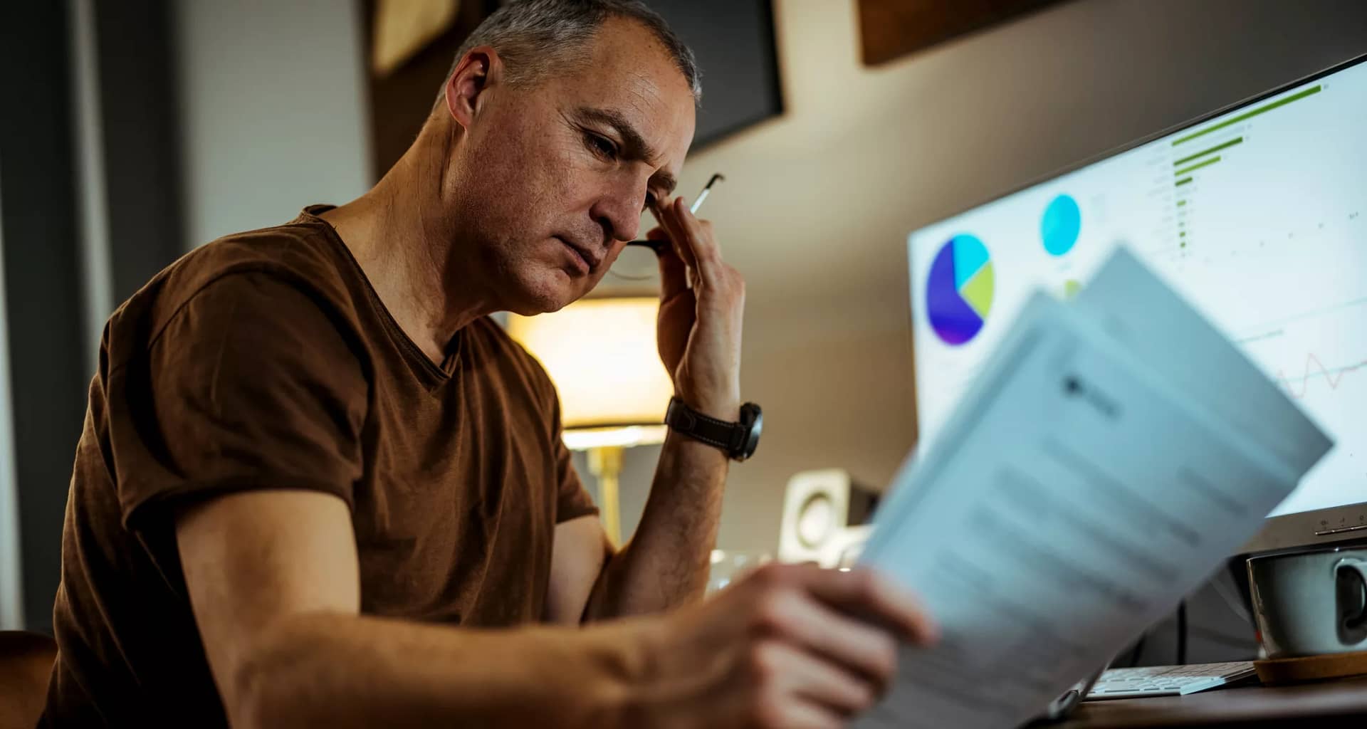middle aged man serious looking at documents.jpg