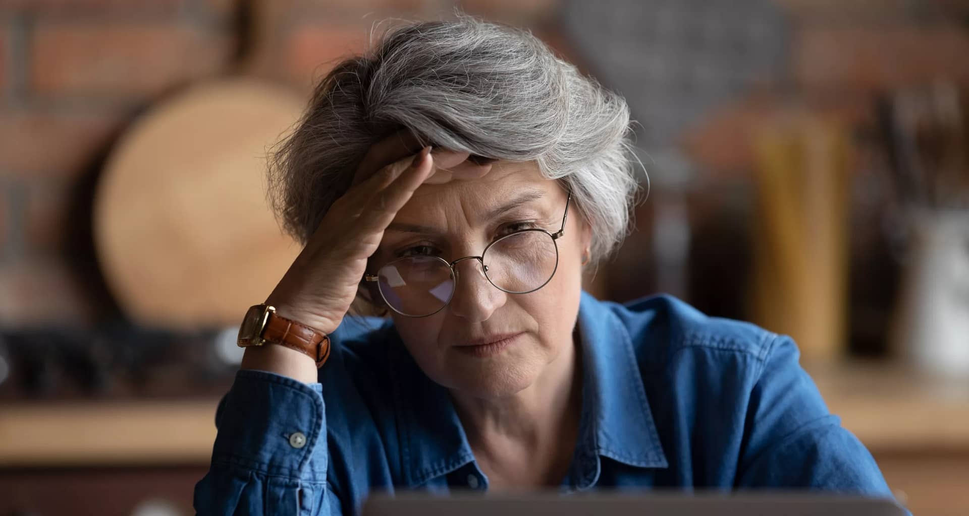 retiree staring at computer in distress.jpg