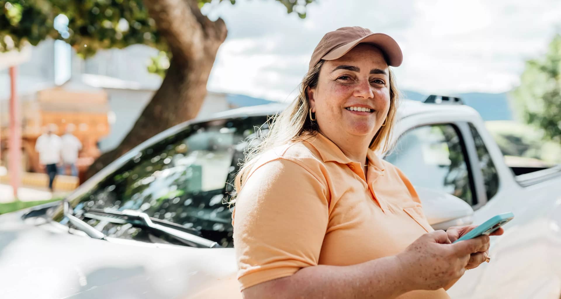 getty someone is standing by a car smiling.jpg