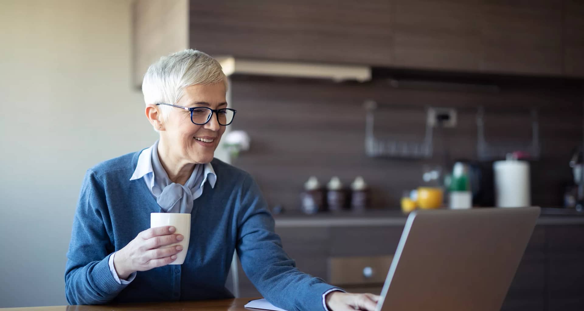 older person looking at a laptop and smiling.jpg