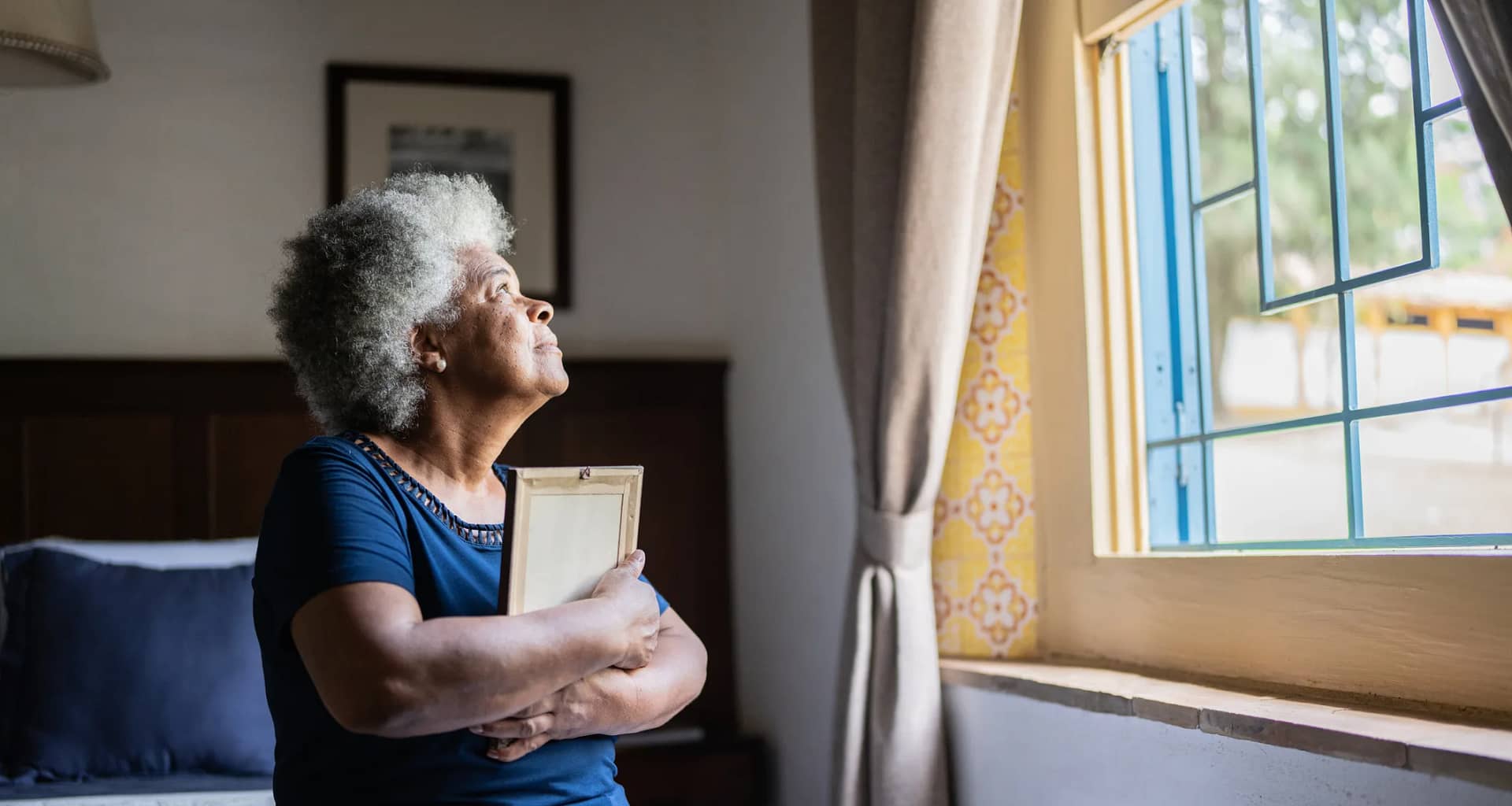 mourning loved one holding picture frame.jpg