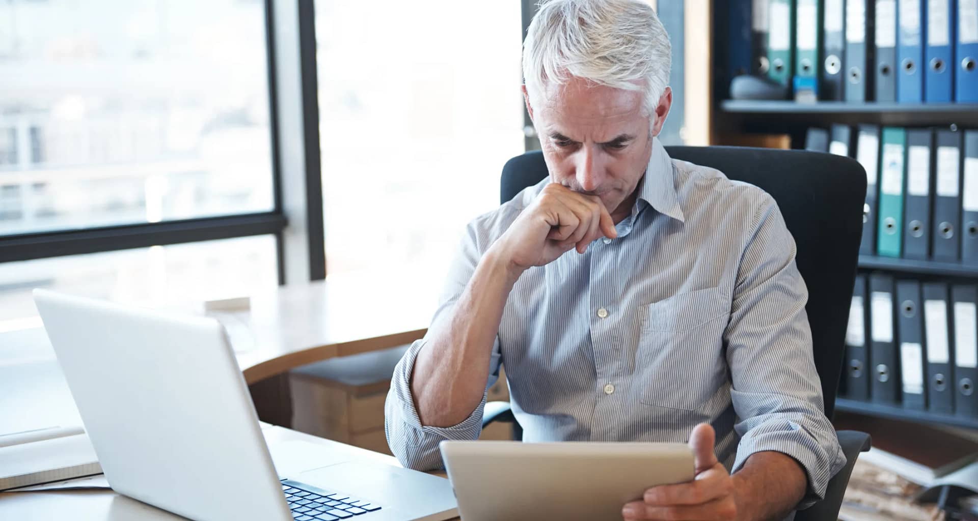 older man desk tablet serious gettyimages .jpg