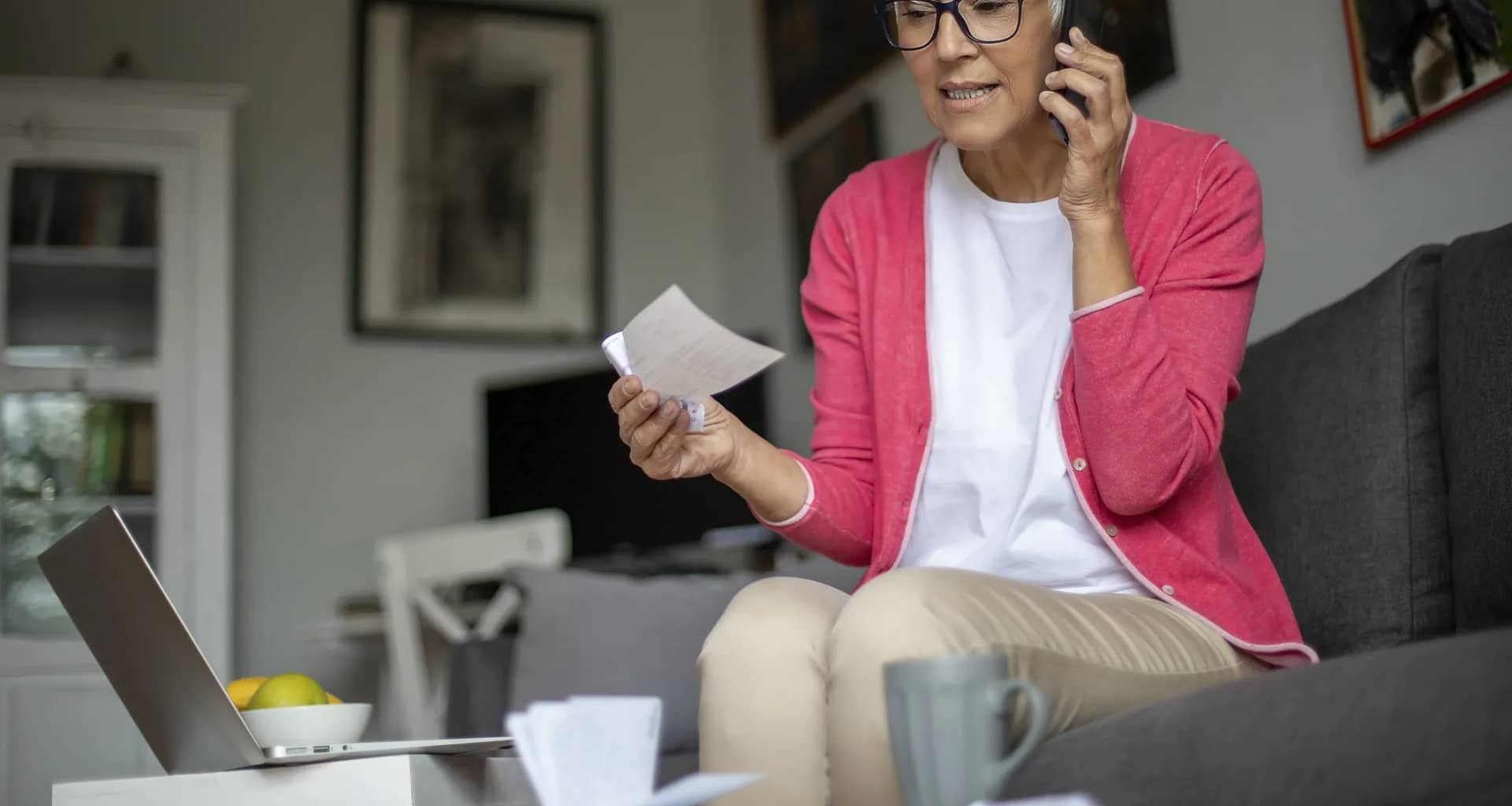 senior holding check and talking on phone.jpg