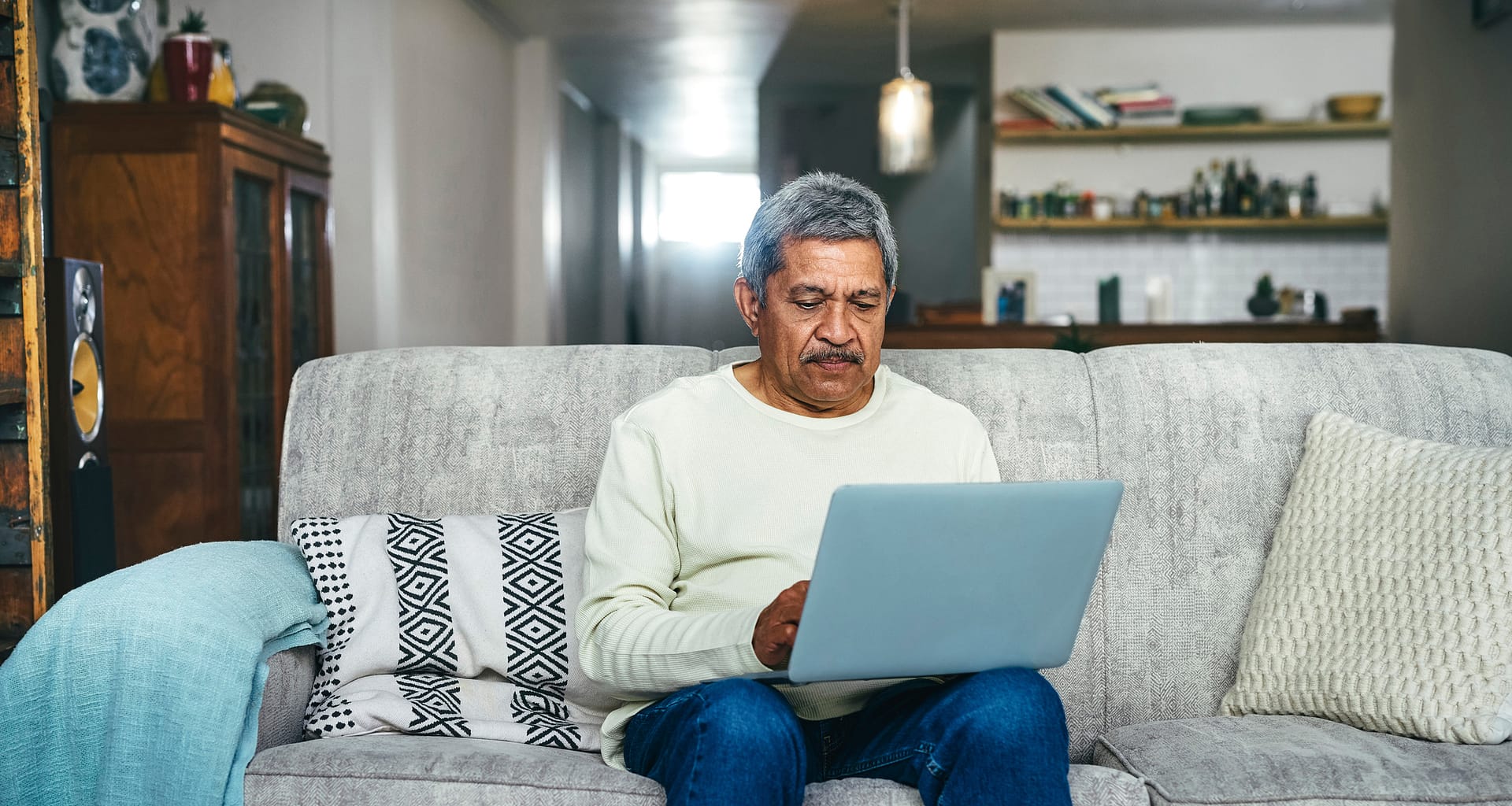 senior man laptop couch gettyimages .jpg