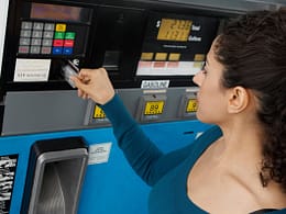 Woman using a credit card to pay at the gas p.width ihWlo.jpg