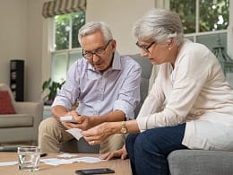 retired couple looking at financial paperwork.jpg