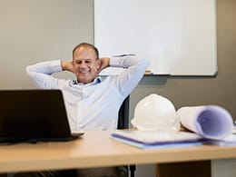 man s desk smiling gettyimages .jpg