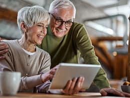 smiling couple looking at tablet together.jpg