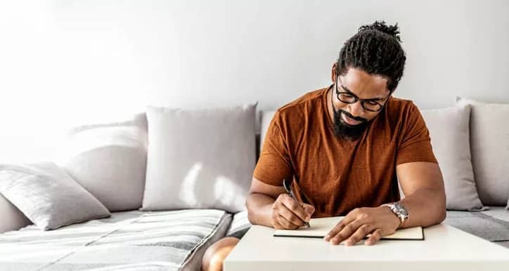 man on couch writing in notebook YuEdzZp.width .jpg