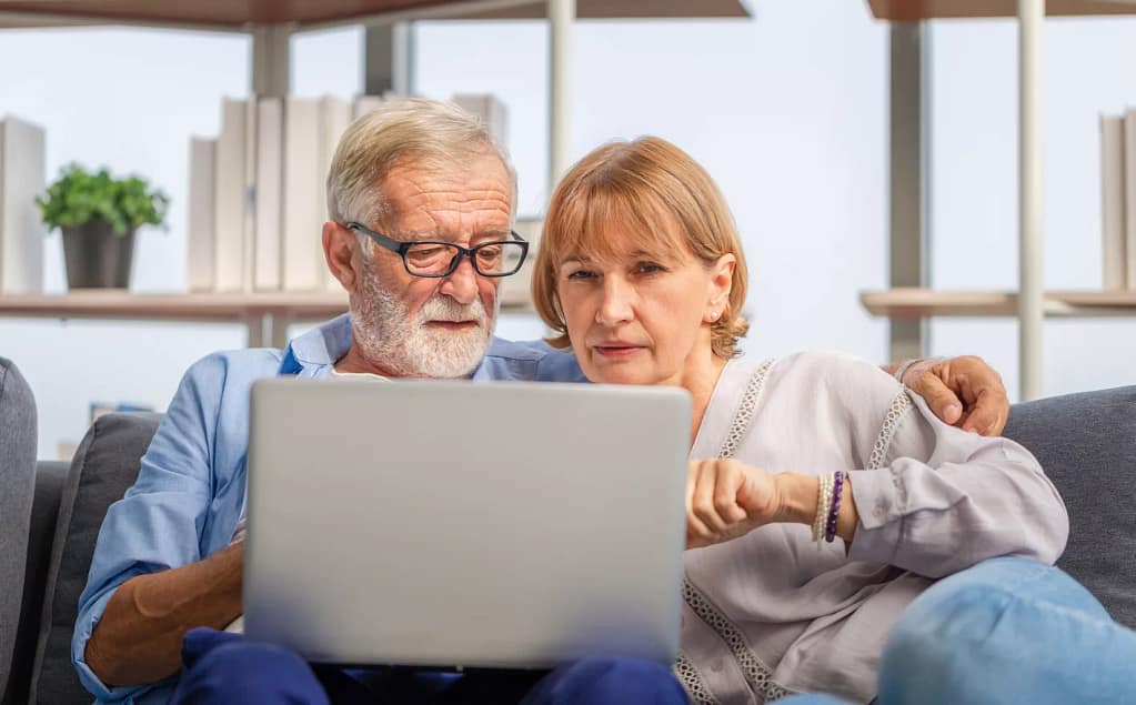 perplexed senior couple looking at laptop.jpg