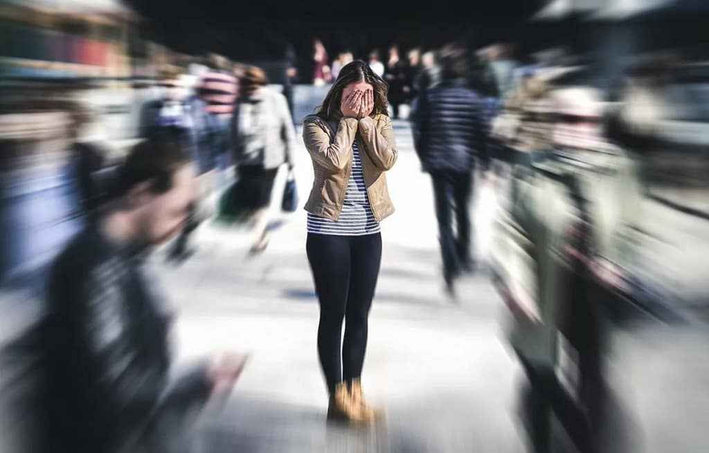 stressed woman in a crowd qwCPxlg.width .jpg