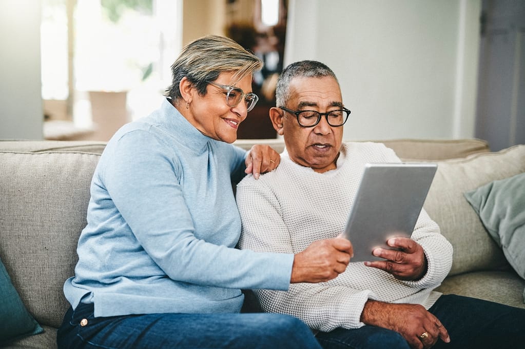 senior couple using a digital tablet at home QWPBm