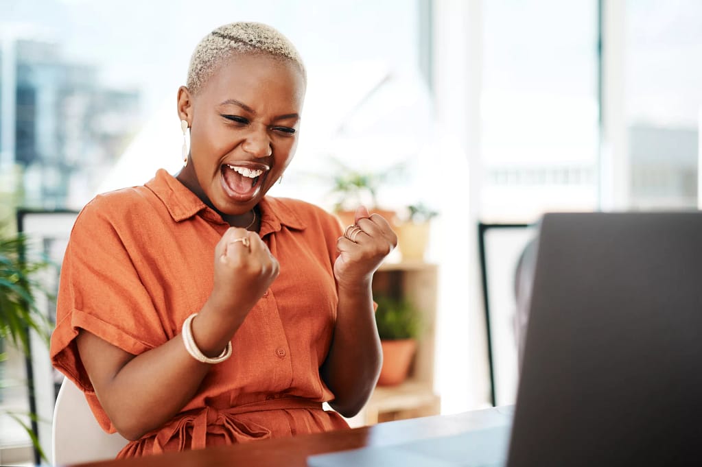 person celebrating victory while looking at computer.jpg