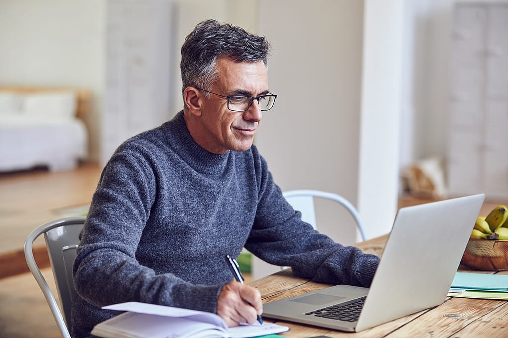 middle aged man notes laptopgettyimages