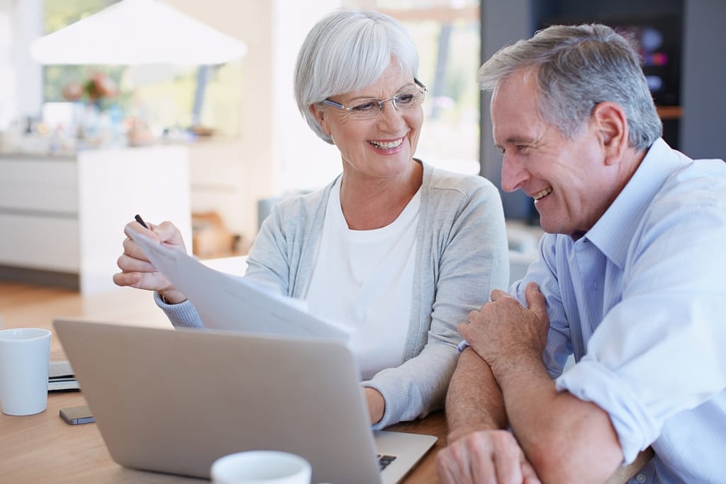 senior couple smiling laptop gettyimages