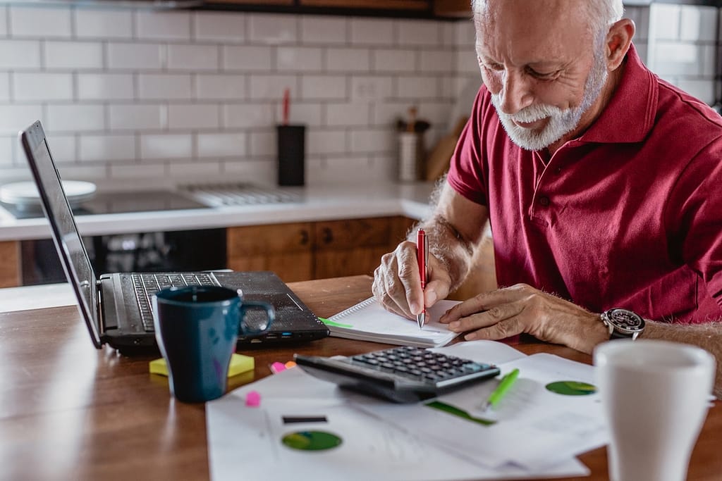 senior man is planning a home budget