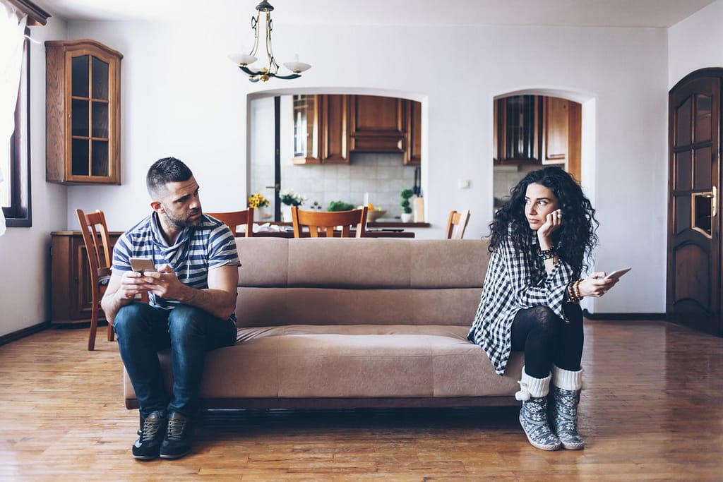 man and woman sitting at opposite ends of a c.width okzr.jpg