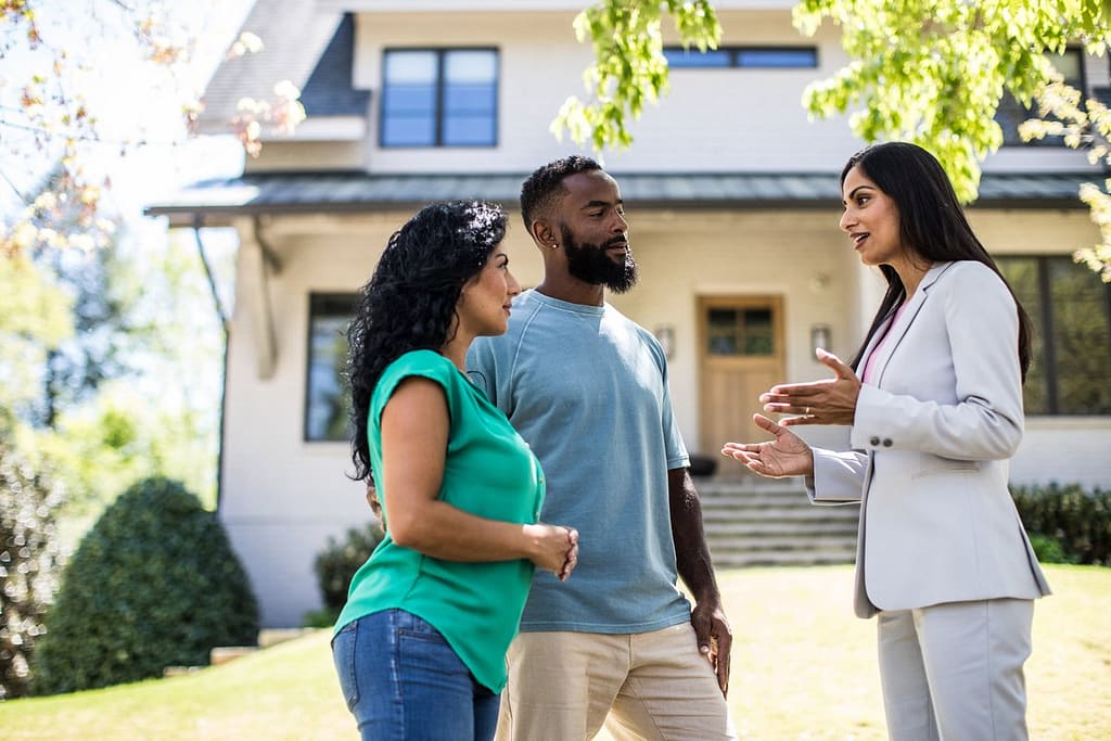 two people with realtor outside house KeFovDR.width .jpg