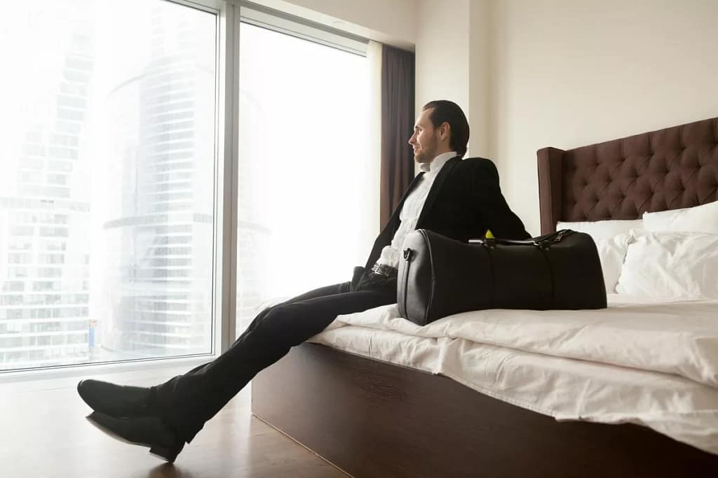 man in suit on hotel bed GCmlvmw.width .jpg