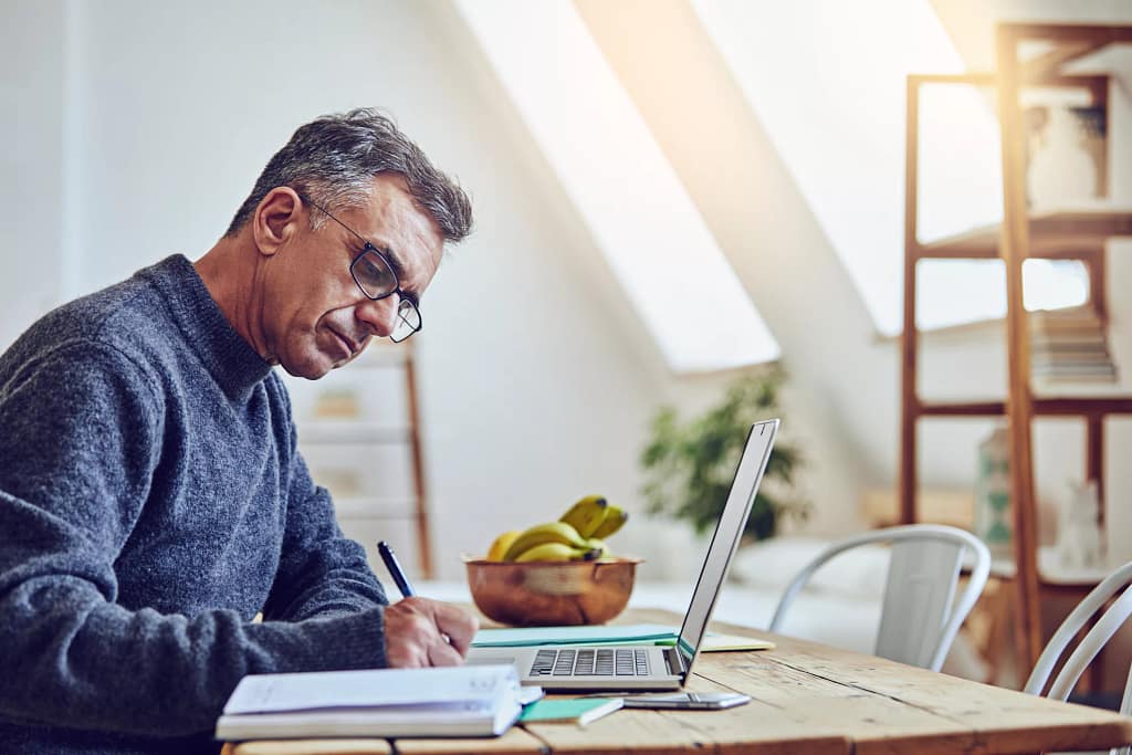 older man at laptop taking notes gettyimages .jpg