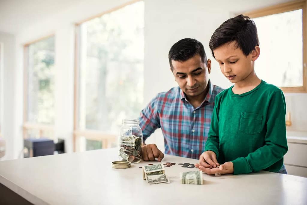 Father and son counting money at home zJVwCZ.width .jpg