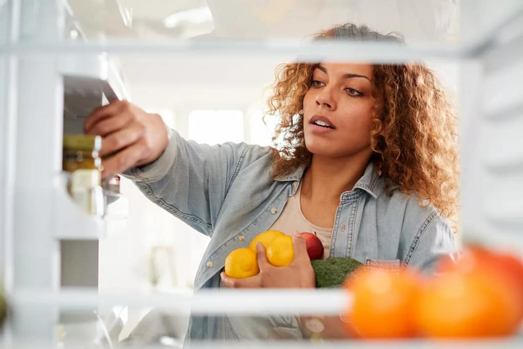 Woman looking in refrigerator.width .jpg
