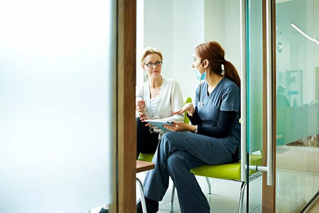 person with medical professional in exam room.width ENskWkF.jpg